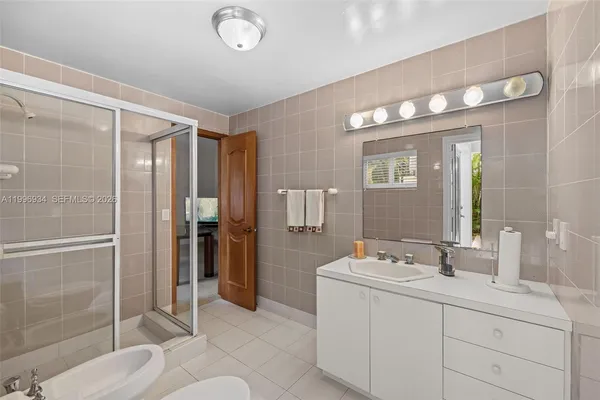 a view of a yard with plants and large trees