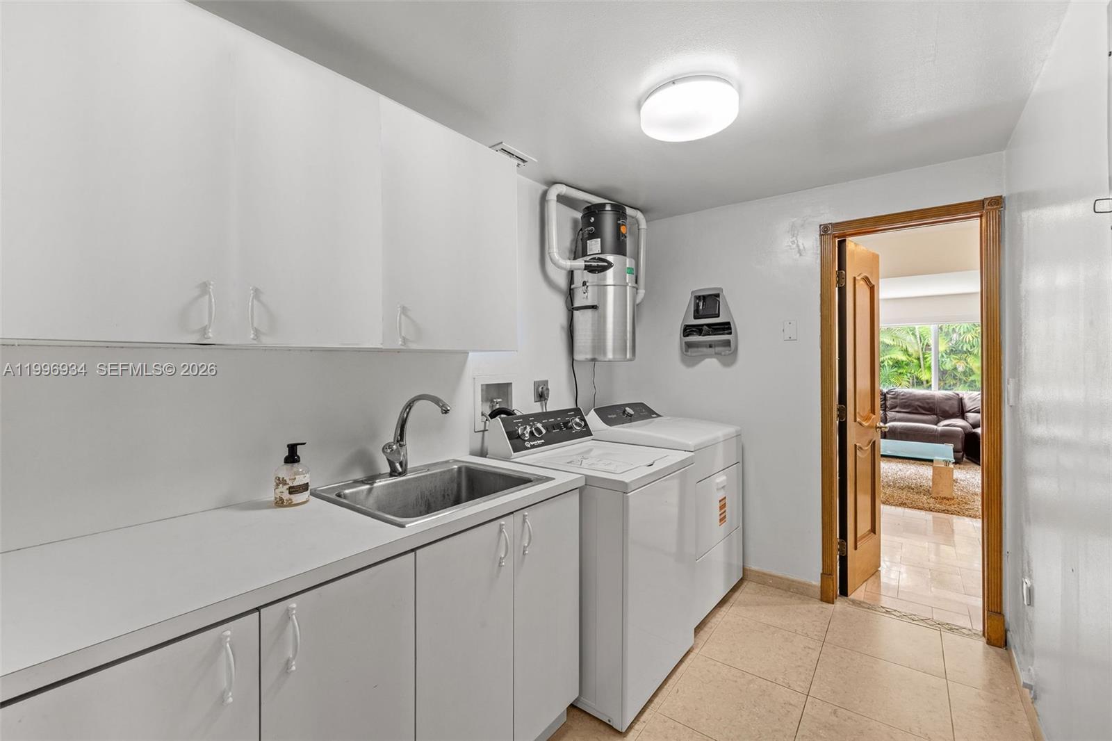8450 Southwest 74th Terrace Miami, FL 33143 - Photo 51 of 54 a kitchen with stainless steel appliances granite countertop a sink and a white cabinets
