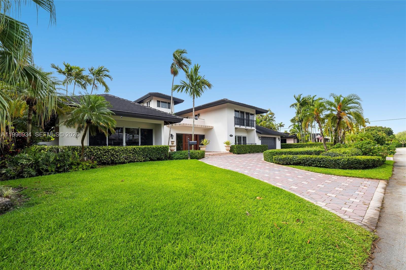 8450 Southwest 74th Terrace Miami, FL 33143 - Photo 53 of 54 a front view of a house with a yard and potted plants