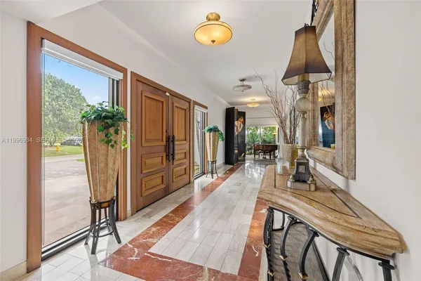 a dining room with furniture a chandelier and a rug