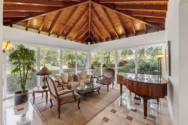 a kitchen with stainless steel appliances kitchen island granite countertop a table and chairs in it