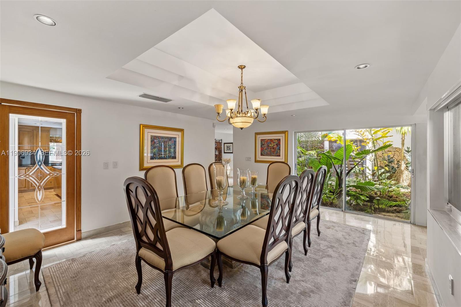 8450 Southwest 74th Terrace Miami, FL 33143 - Photo 9 of 54 a view of a dining room with furniture a chandelier and large windows
