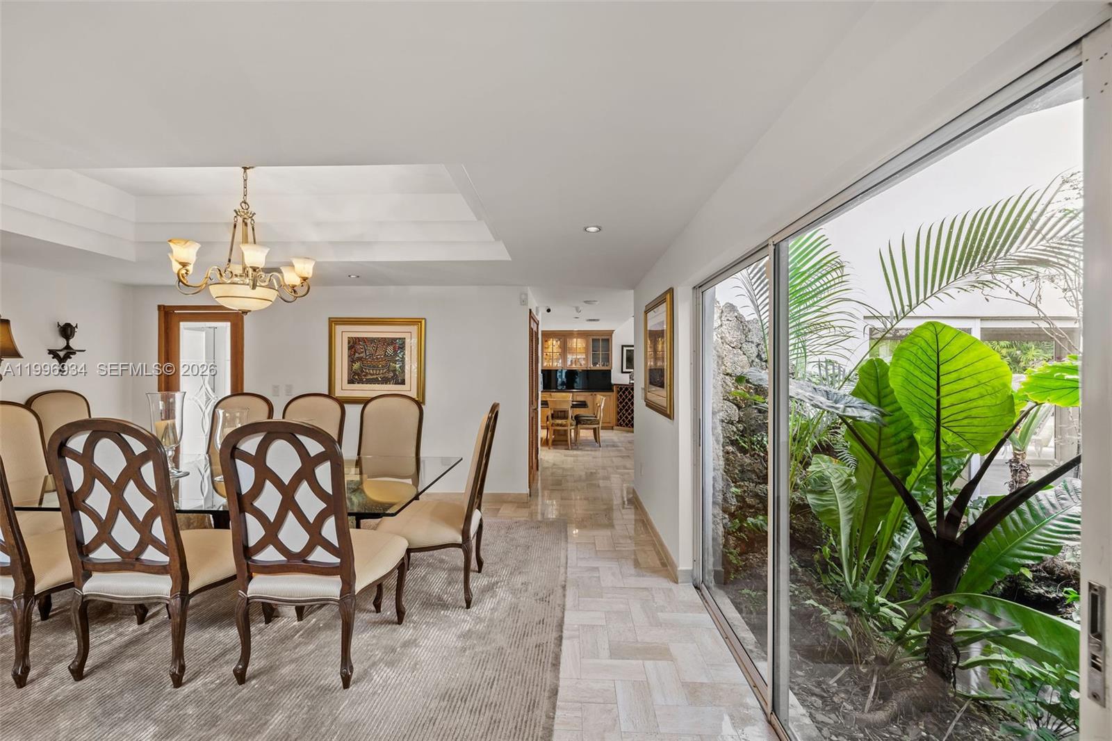8450 Southwest 74th Terrace Miami, FL 33143 - Photo 10 of 54 a dining room with furniture a chandelier and a rug