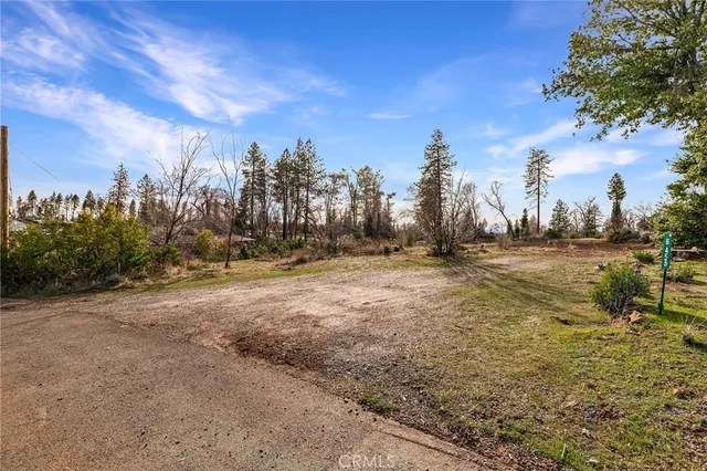 a view of dirt field with trees