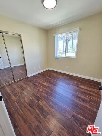 a view of a room with wooden floor and glass window