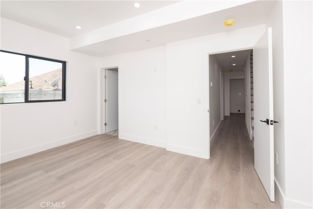 1571 Ricardo Street Los Angeles, CA 90033 - Photo 11 of 29 a view of a hallway with wooden floor and a bathroom