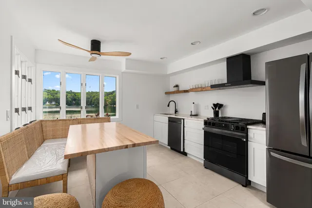 a kitchen with stainless steel appliances a stove a refrigerator and a sink