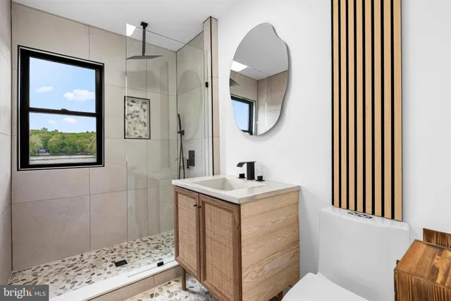 a bathroom with a sink a mirror and a toilet