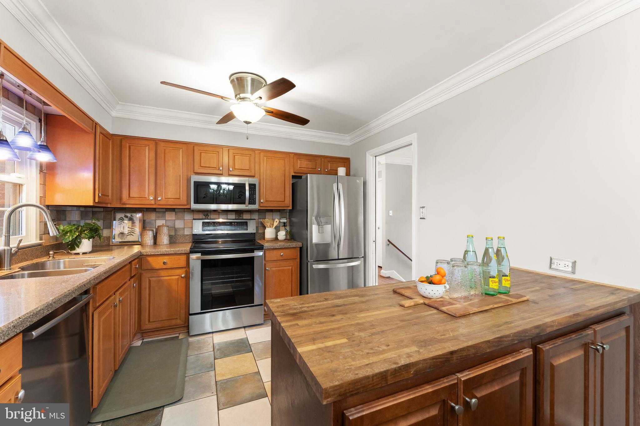 6101 Briarview Court Alexandria, VA 22310 - Photo 13 of 44 a kitchen with a stove a sink and a refrigerator