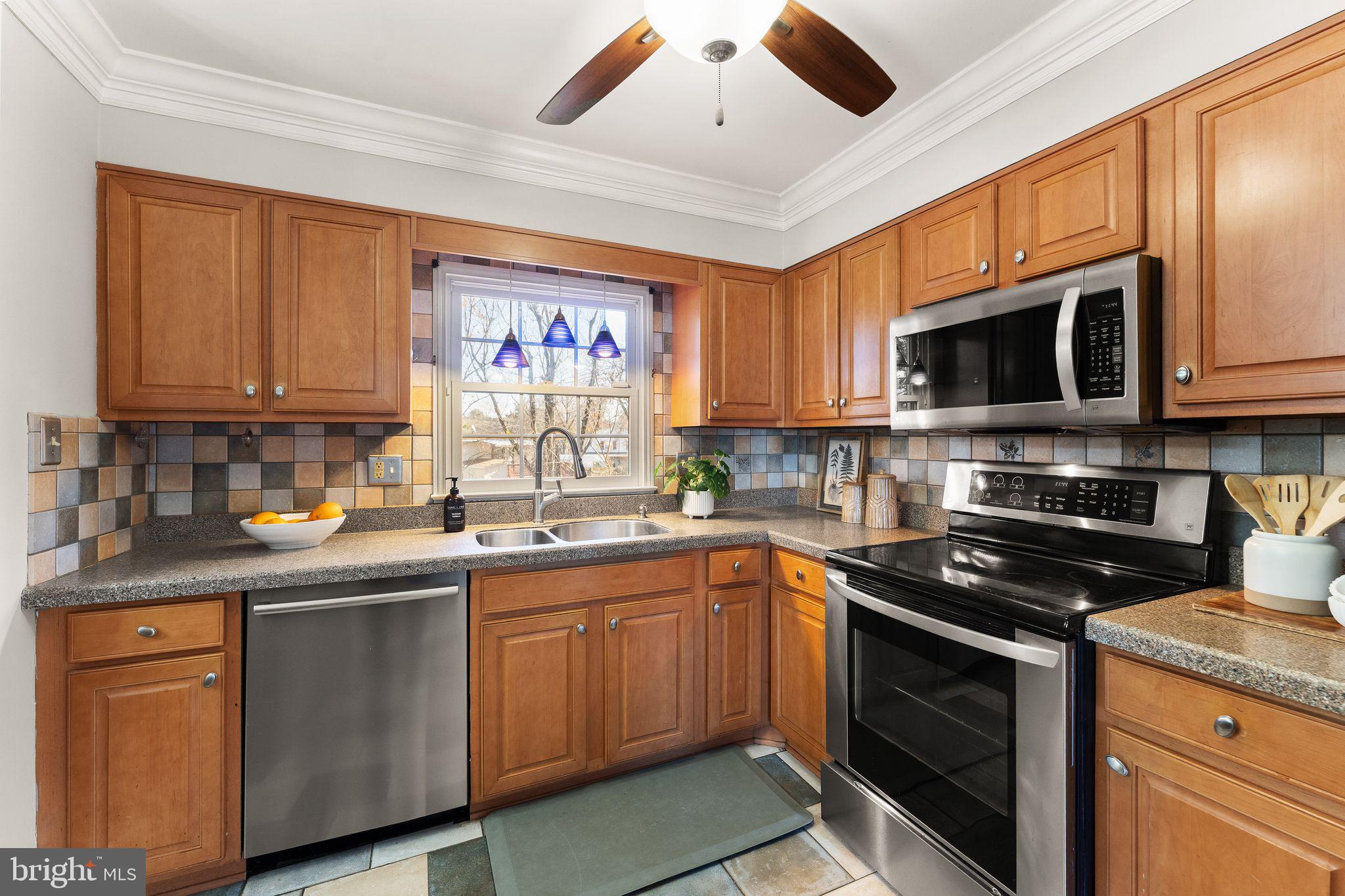 6101 Briarview Court Alexandria, VA 22310 - Photo 15 of 44 a kitchen with stainless steel appliances granite countertop a stove sink microwave and refrigerator