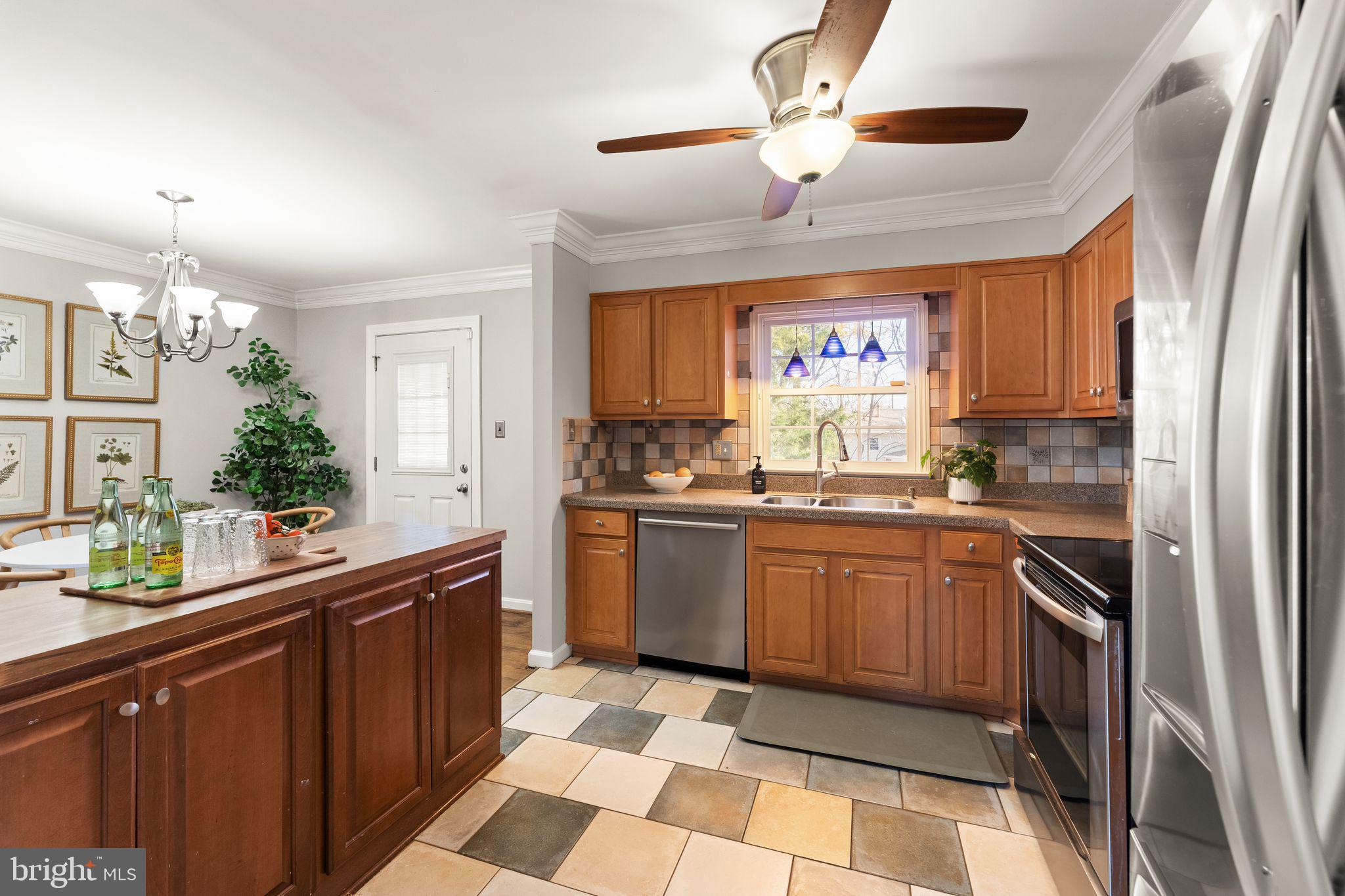 6101 Briarview Court Alexandria, VA 22310 - Photo 16 of 44 a kitchen with a sink a stove and cabinets