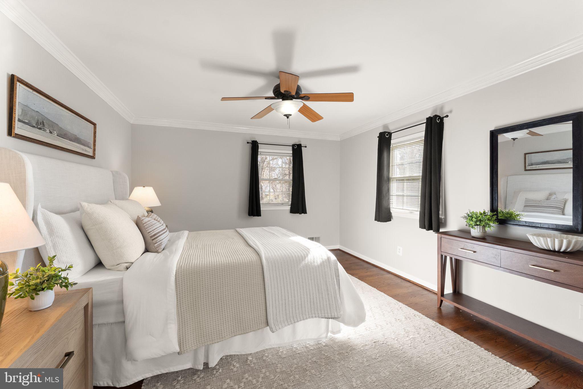 6101 Briarview Court Alexandria, VA 22310 - Photo 17 of 44 a bedroom with a large bed and a chandelier fan