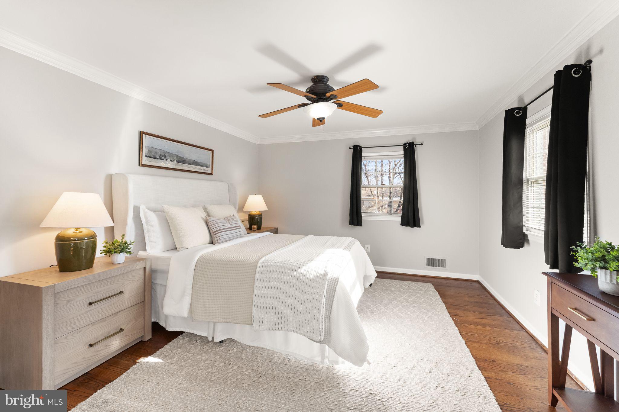 6101 Briarview Court Alexandria, VA 22310 - Photo 19 of 44 a bedroom with a large bed and a chandelier fan