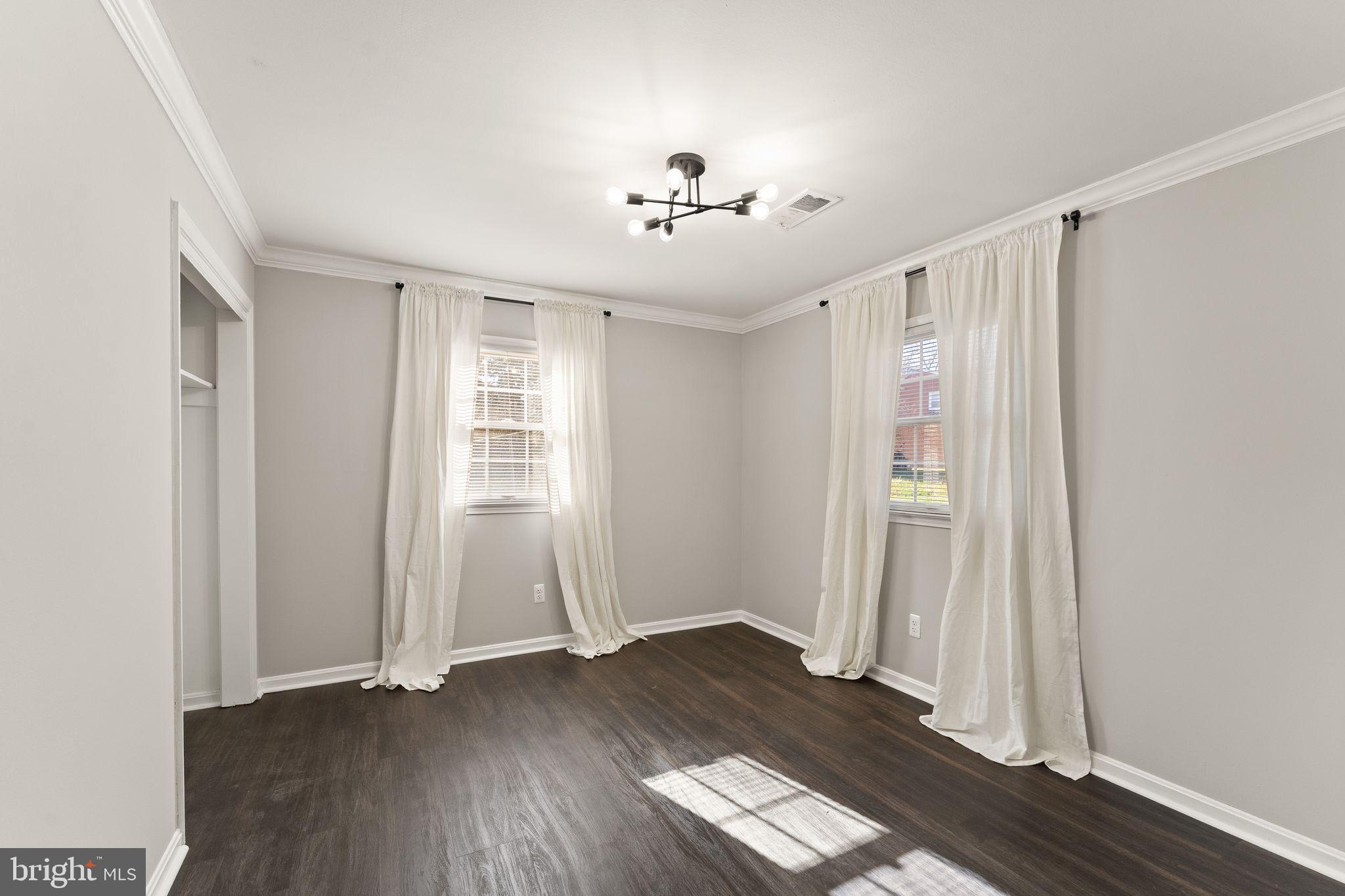 6101 Briarview Court Alexandria, VA 22310 - Photo 30 of 44 an empty room with wooden floor staircase and windows