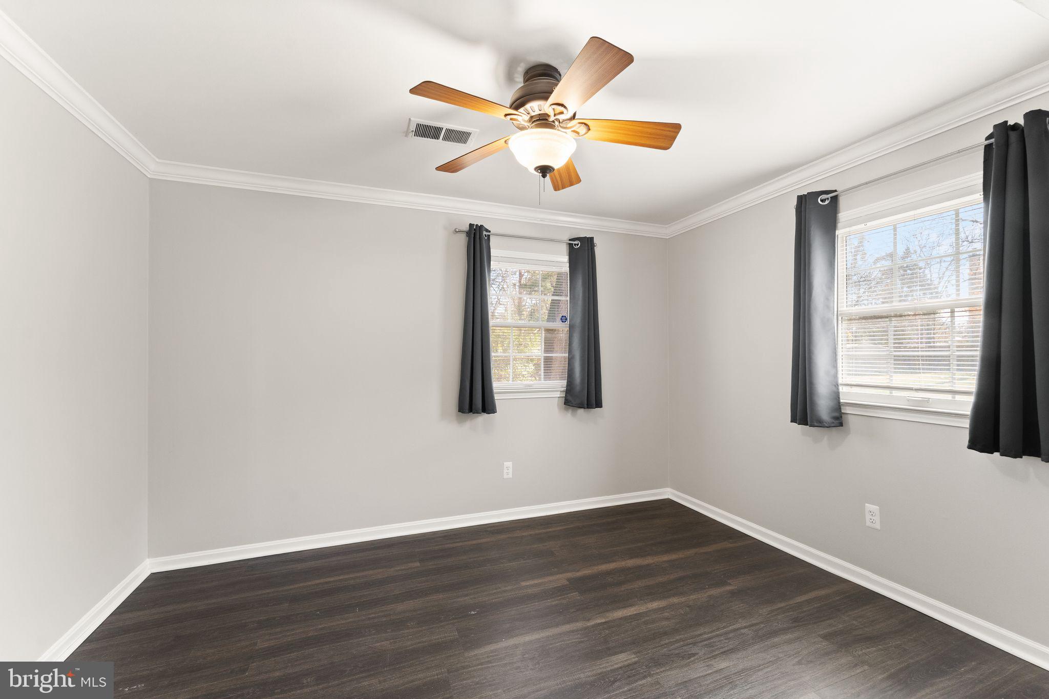 6101 Briarview Court Alexandria, VA 22310 - Photo 34 of 44 a view of an empty room with wooden floor and a window
