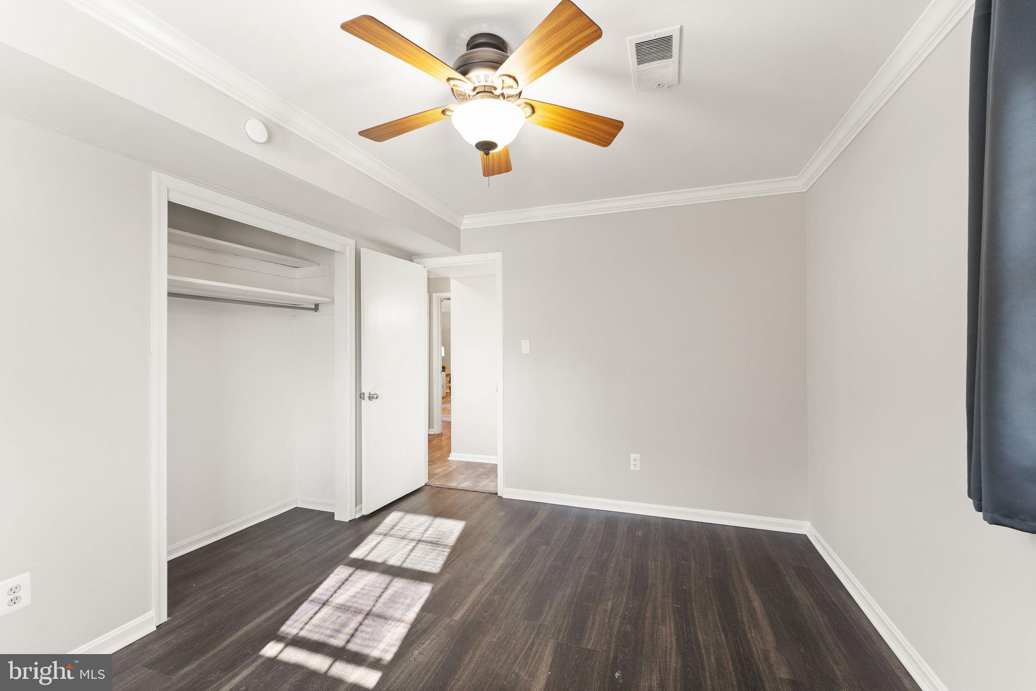 6101 Briarview Court Alexandria, VA 22310 - Photo 35 of 44 an empty room with wooden floor and a ceiling fan