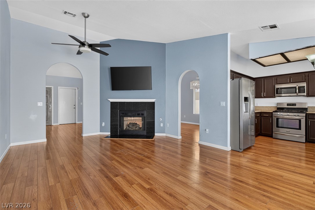 2609 Shakespeare Road Las Vegas, NV 89108 - Photo 13 of 41 A striking black fireplace anchors this generous family room, flowing seamlessly into a well-appointed kitchen.