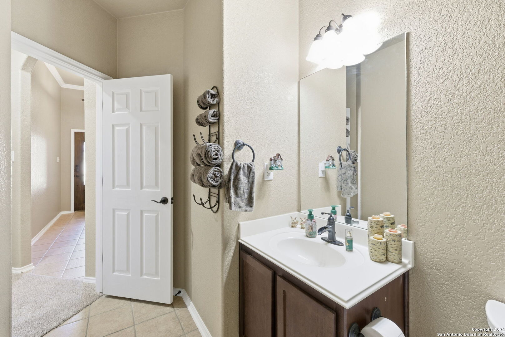 10510 Corvey Lane Helotes, TX 78023 - Photo 11 of 40 a bathroom with a sink a mirror and a shower
