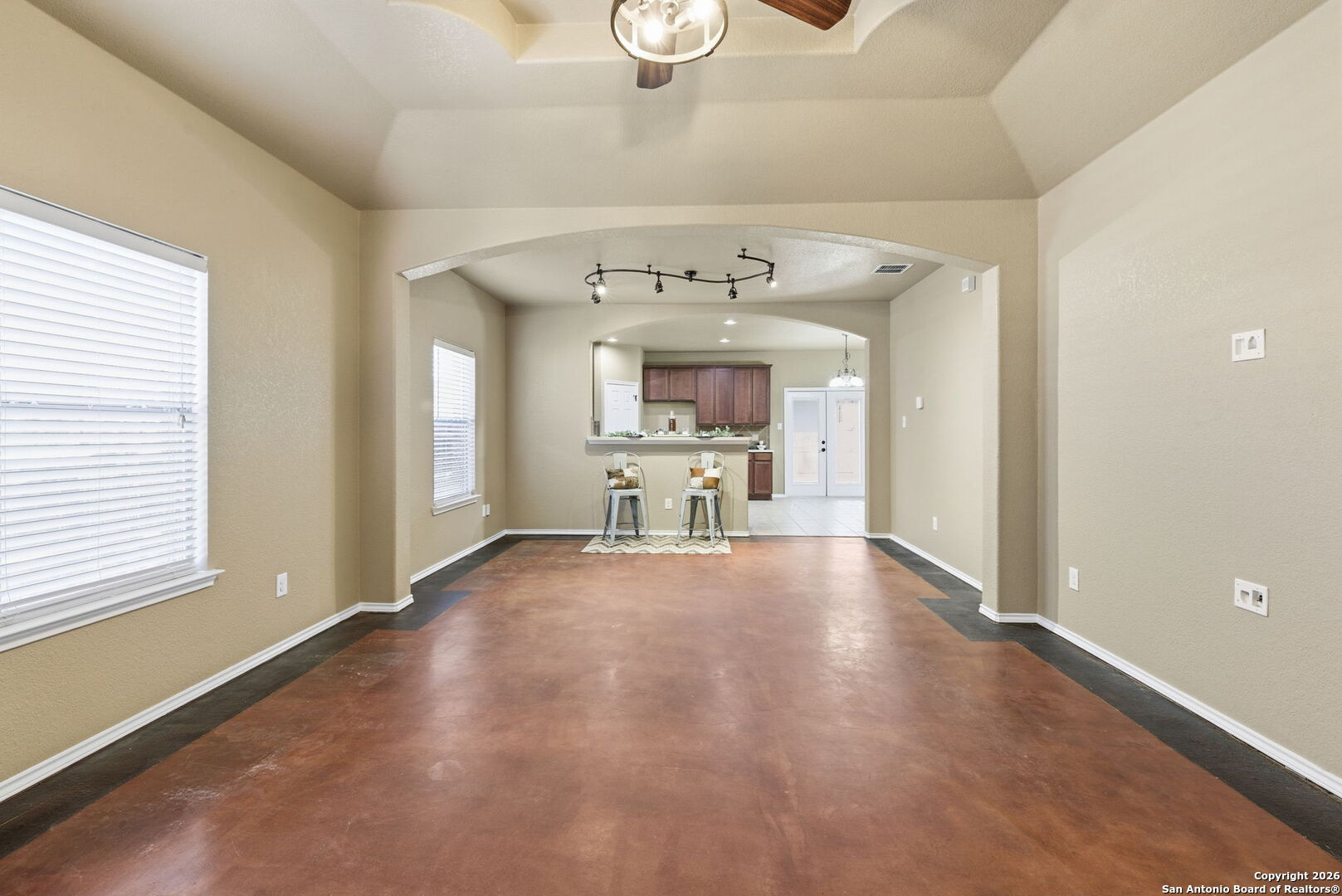 10510 Corvey Lane Helotes, TX 78023 - Photo 14 of 40 a view of a livingroom with a fireplace a chandelier and windows