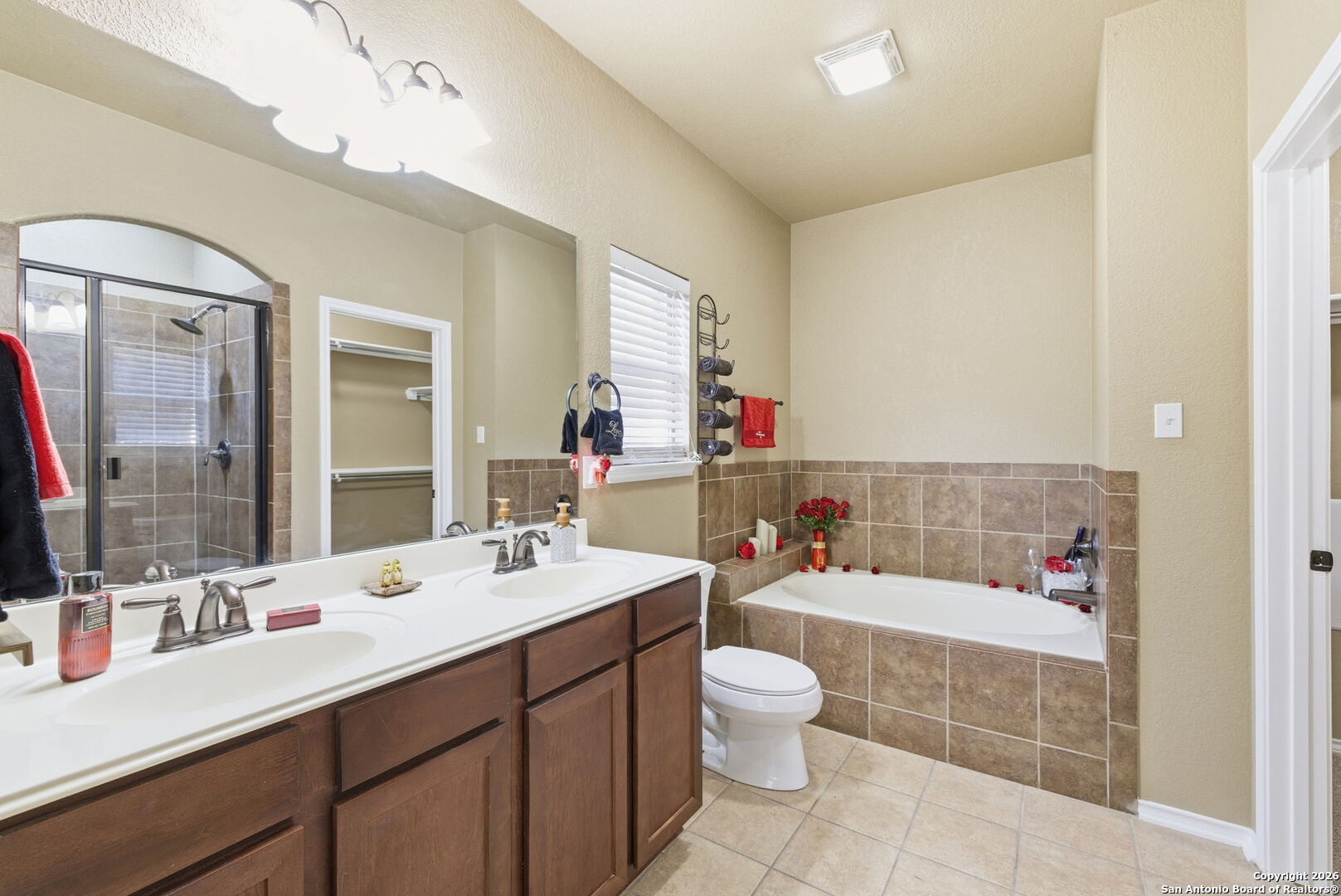 10510 Corvey Lane Helotes, TX 78023 - Photo 29 of 40 a bathroom with a double vanity sink mirror and toilet