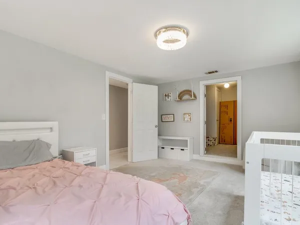 a bedroom with a bed and a view of bathroom