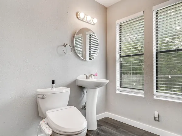 a white toilet sitting next to a bathroom sink