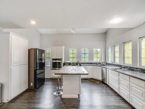 a large kitchen with lots of counter space and stainless steel appliances