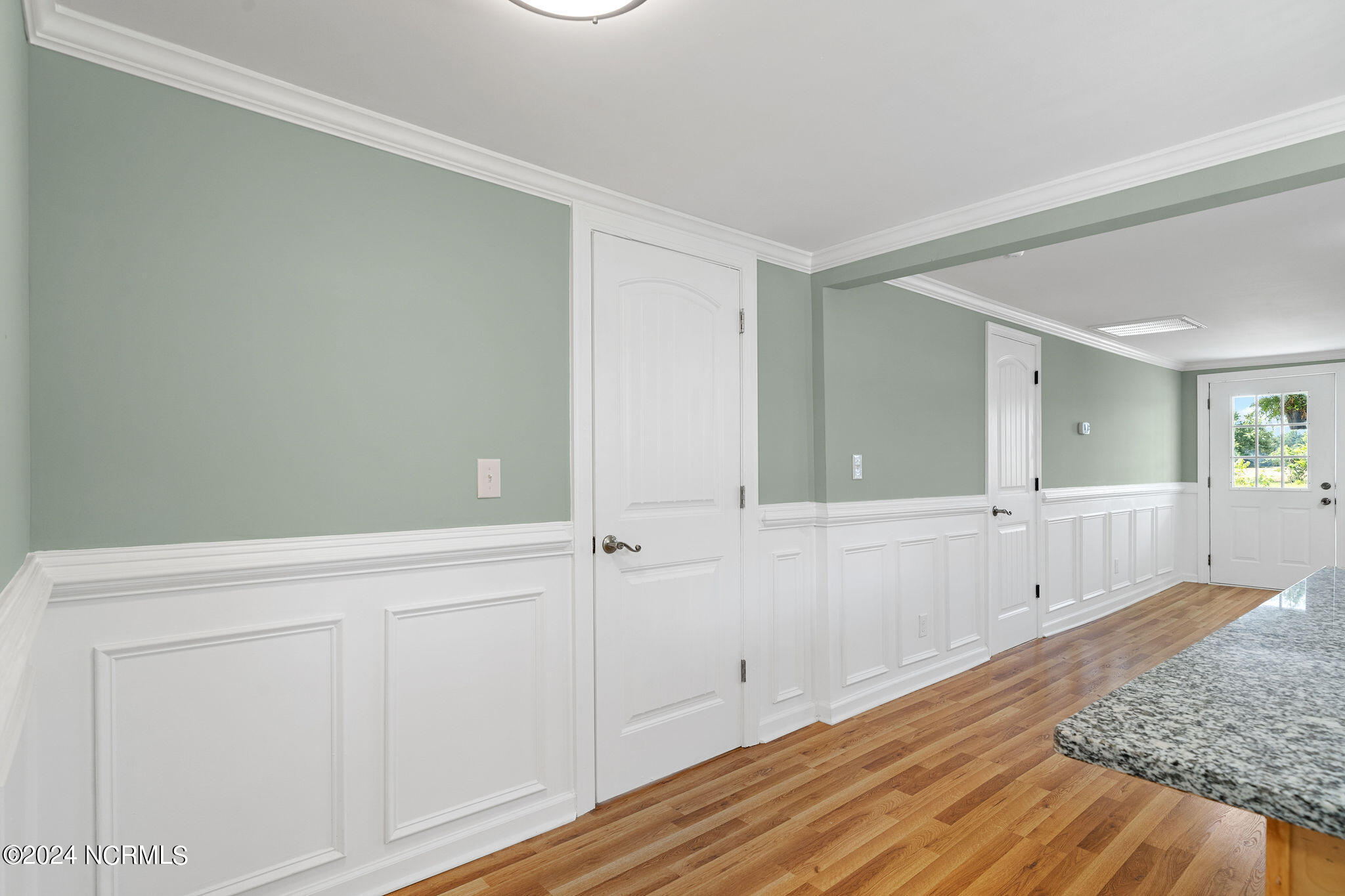 287 Murphys Store Road Rose Hill, NC 28458 - Photo 7 of 27 Notice the wainscoting details and the vertical pattern on the doors compliment one another. This vertical pattern mimics the bead board pattern on the island