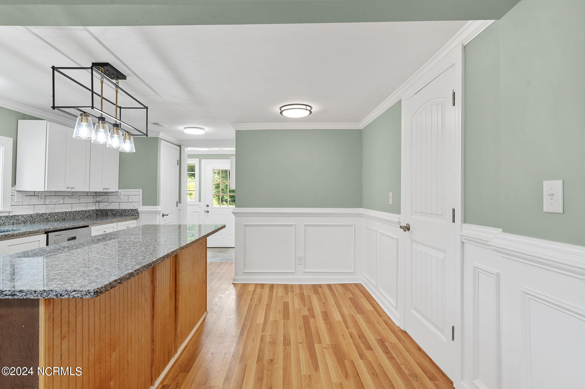287 Murphys Store Road Rose Hill, NC 28458 - Photo 27 of 27 The timeless white cabinets are offset by the warm tones on the Kitchen island. In the far upper left corner is the full Pantry next to the Utility Room. The half glass door leads to a wrap around Deck. Great floor plan for entertaining!!!!