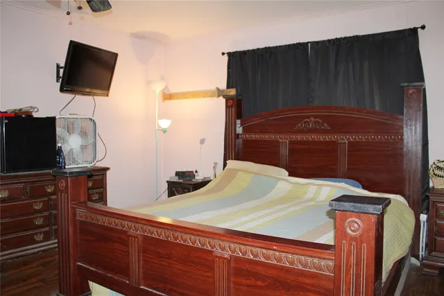 a bedroom with a bed and flat screen tv