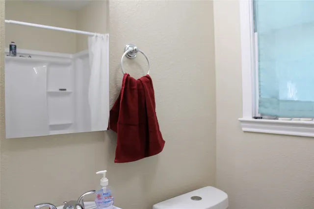 a bathroom with a shower curtain and a toilet