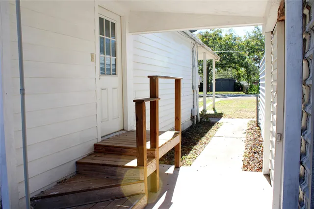 a view of balcony with wooden floor and a potted plant
