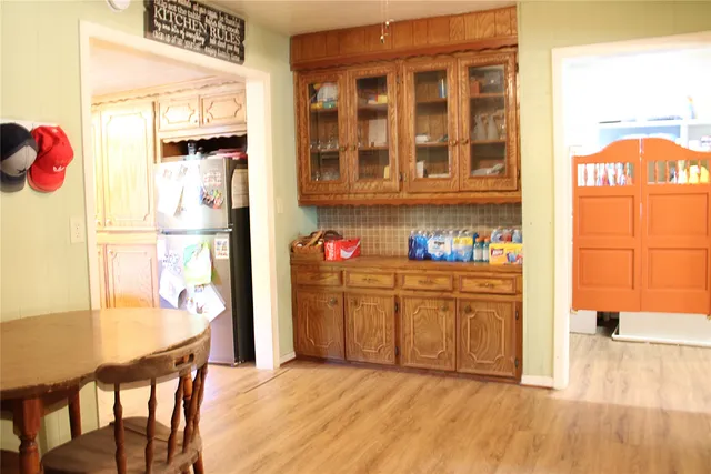 a kitchen with granite countertop a refrigerator and cabinets