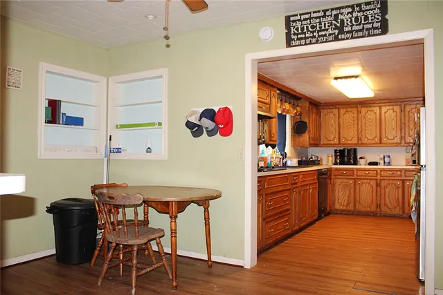 a kitchen with stainless steel appliances granite countertop a white cabinets and wooden floor