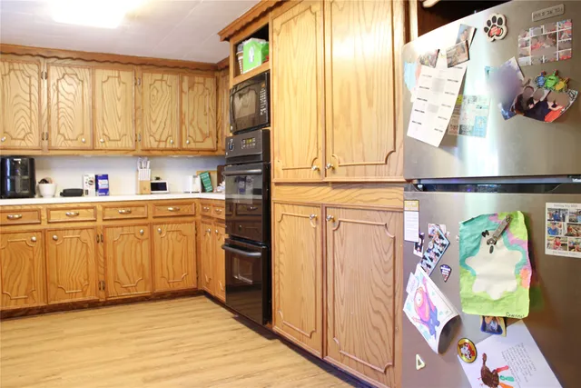 a kitchen with stainless steel appliances a sink a stove and a window