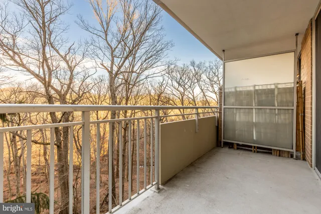 a view of a balcony with wooden floor and fence