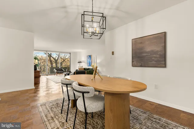 a dining room with furniture and wooden floor