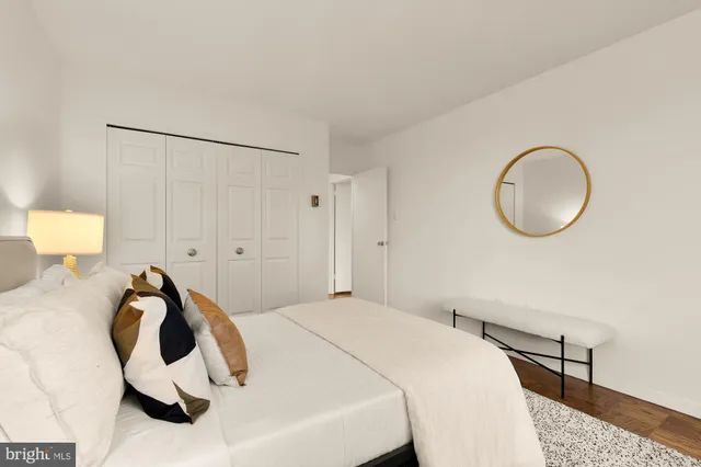 a bedroom with a bed and a lamp