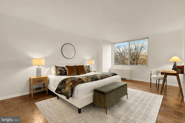 a bed room with a bed and a chair