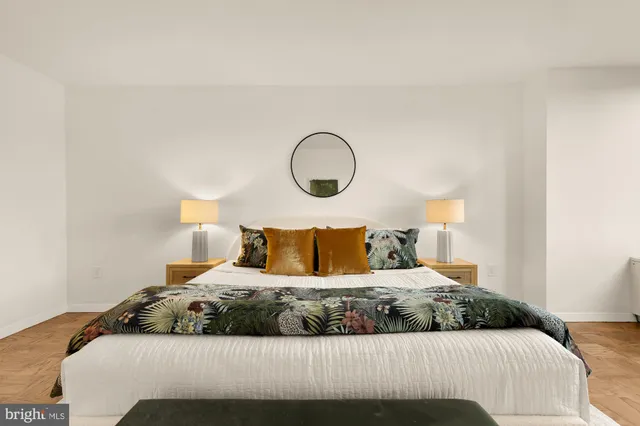 a bedroom with a large bed and a lamp