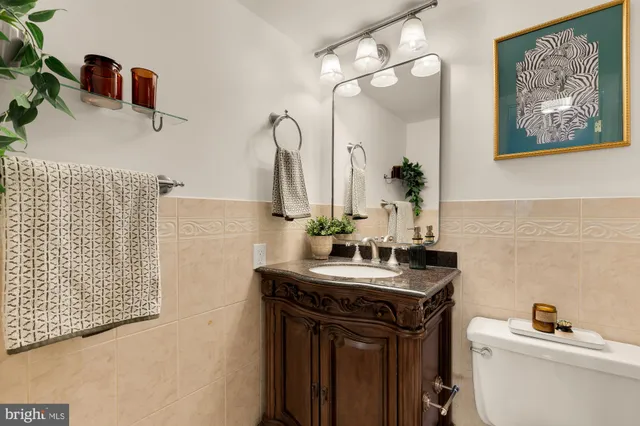 a bathroom with a sink vanity and toilet