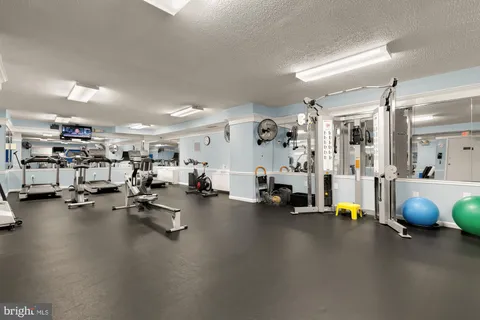 a view of a workspace with furniture window and wooden floor
