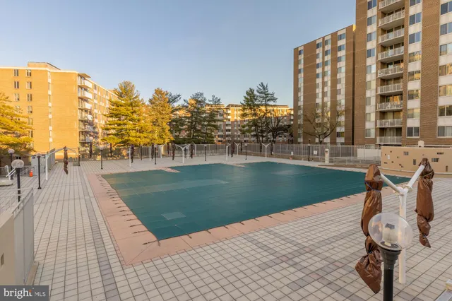 a view of swimming pool with outdoor seating and city view