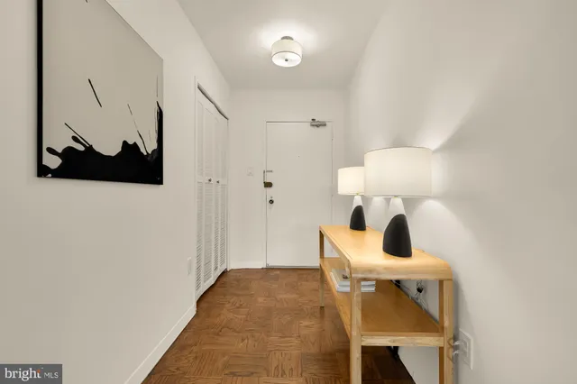 a living room with a bed and a painting on the wall