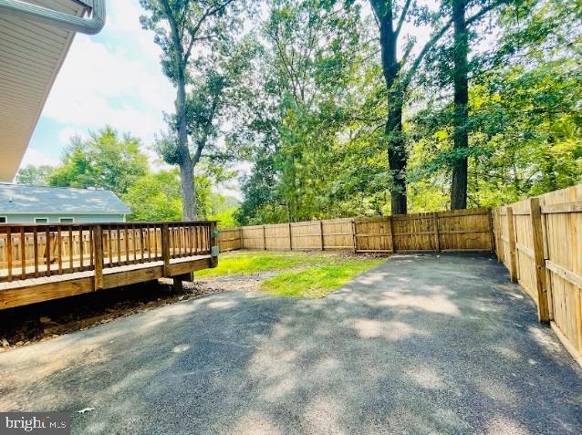 220 5th Street Colonial Beach, VA 22443 - Photo 19 of 25 a view of backyard with wooden fence and a large tree
