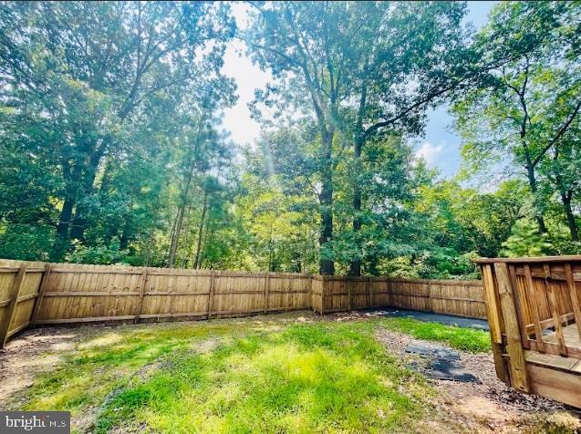 220 5th Street Colonial Beach, VA 22443 - Photo 20 of 25 a view of backyard with wooden fence and a fence