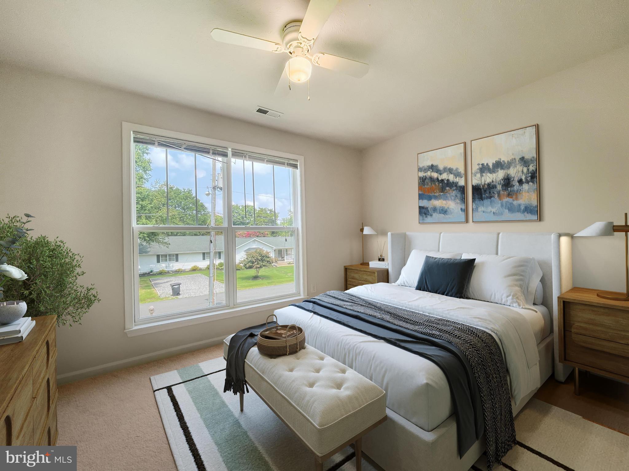 220 5th Street Colonial Beach, VA 22443 - Photo 6 of 25 a bedroom with a bed and a chair