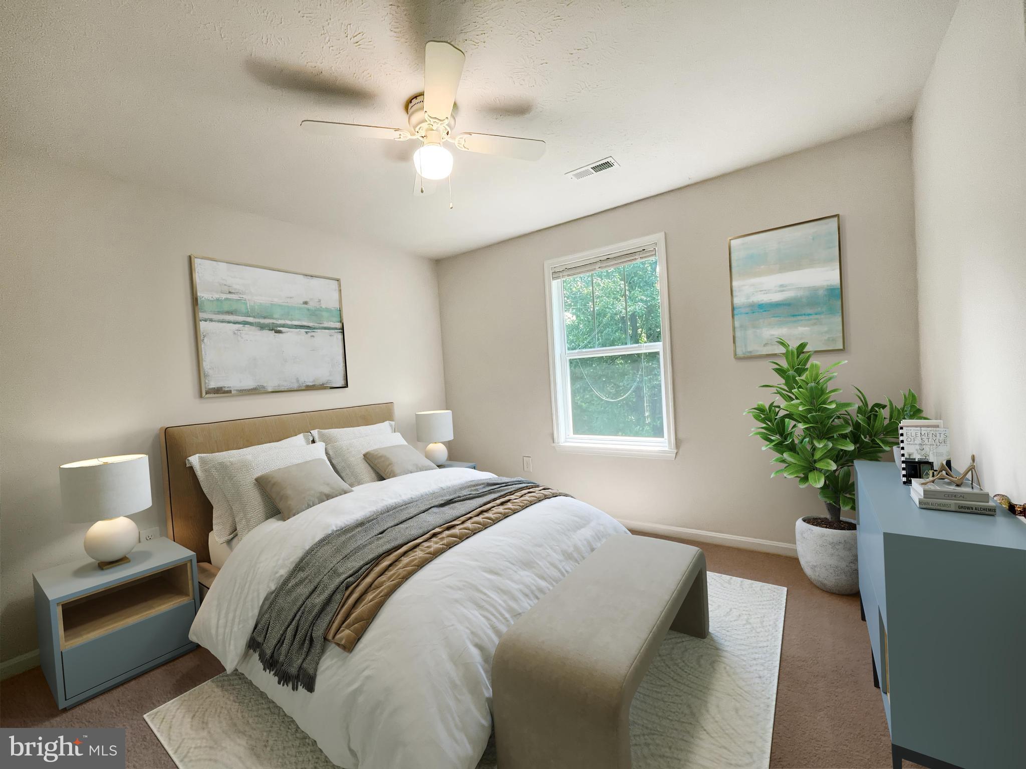 220 5th Street Colonial Beach, VA 22443 - Photo 7 of 25 a bedroom with a large bed and a potted plant