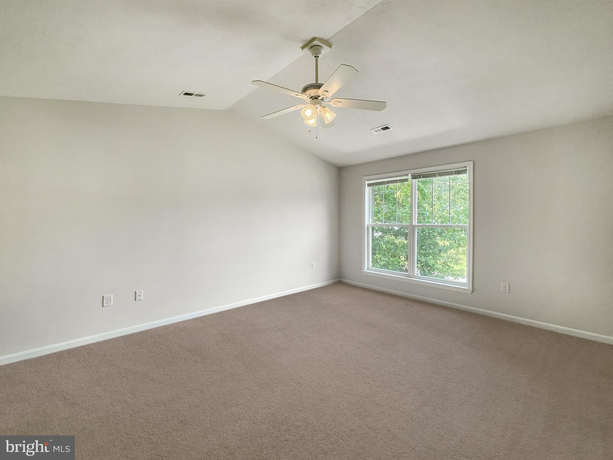 220 5th Street Colonial Beach, VA 22443 - Photo 10 of 25 an empty room with a window and a fan
