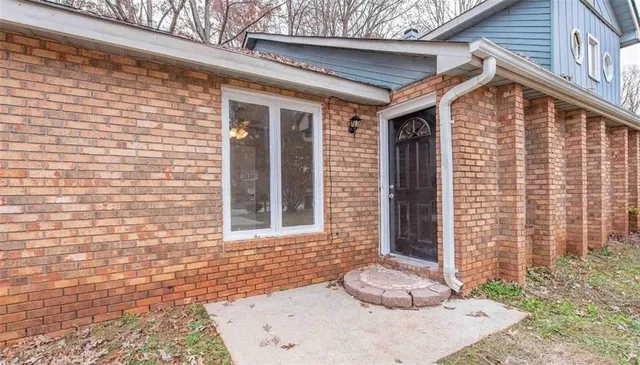 a front view of a house with a large window